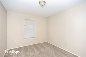 Garland house for rent - a spacious room with carpet and a window