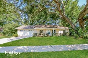 Sanford house for rent - a white house with a lawn and trees