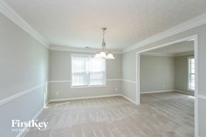 Acworth house for rent - an empty dining room with a chandelier and a window