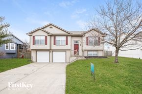 Greenwood house for rent - A house with a red door and a sign that says FirstKey Homes.