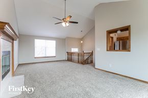 Greenwood house for rent - A spacious room with a ceiling fan and a window.