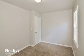 Lee's Summit house for rent - a bedroom with white walls and carpet and a white door
