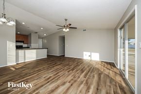 Cape Coral house for rent - A spacious room with wooden flooring and a ceiling fan.