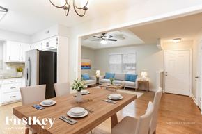 Greenwood house for rent - A dining room with a wooden table set for two.