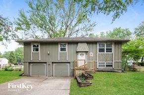 Blue Springs house for rent - a gray house with two garage doors and a driveway