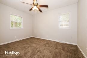 Blue Springs house for rent - a bedroom with carpet and a ceiling fan