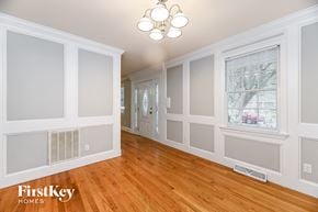 Summerville house for rent - the living room and dining room of a house with white walls and wood floors