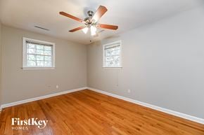 Summerville house for rent - a bedroom with wood floors and a ceiling fan