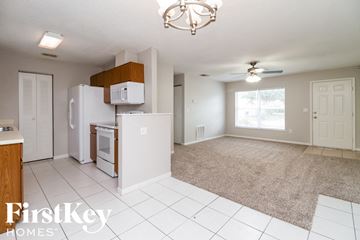 Kissimmee house for rent - A kitchen with a refrigerator, microwave, and oven.