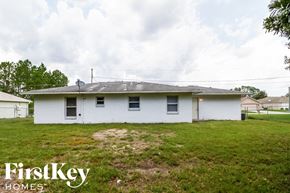 Kissimmee house for rent - A white house with a grassy yard in front of it.