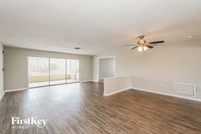 Palm Harbor house for rent - A spacious room with wooden flooring and a ceiling fan.