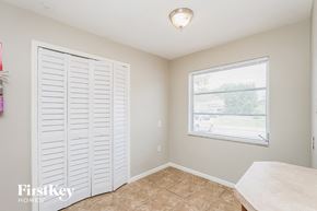 Palm Harbor house for rent - A room with a sliding door and a window.