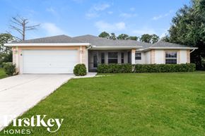 Lehigh Acres house for rent - A house with a garage and a well-kept lawn.