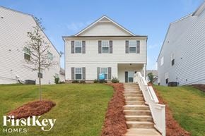 Canton house for rent - a white house with a staircase in front of a green lawn