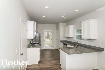Canton house for rent - a white kitchen with marble counter tops and white cabinets