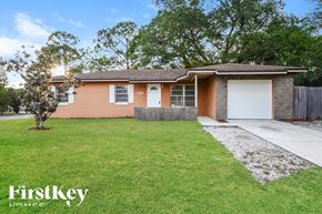 Sanford house for rent - A house with a brown roof and a white garage door is for sale.