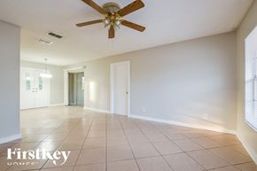 Sanford house for rent - A spacious room with a ceiling fan and tiled floor.