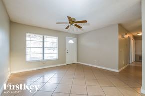 Sanford house for rent - A spacious room with a ceiling fan and tiled flooring.