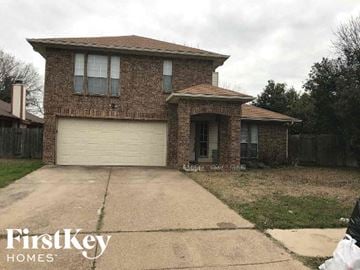 Arlington house for rent - a brick house with a white garage door