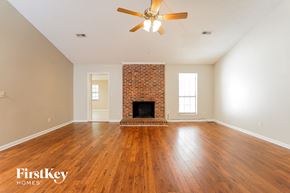 Goose Creek house for rent - the living room with wood floors and a brick fireplace and a ceiling fan