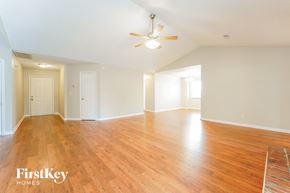 Goose Creek house for rent - the living room and dining room with wood flooring and a ceiling fan