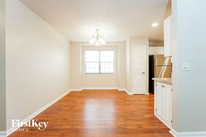 Goose Creek house for rent - an empty living room with wood flooring and a kitchen