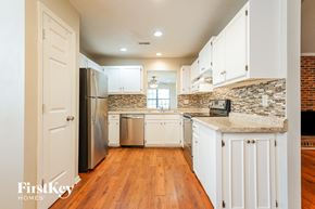 Goose Creek house for rent - a kitchen with white cabinets and a stainless steel refrigerator