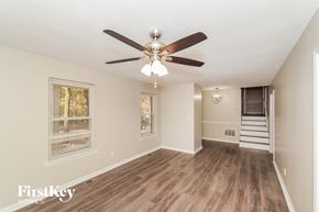 Alabaster house for rent - a living room with a ceiling fan and a staircase