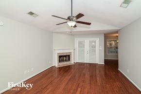 Helena house for rent - a living room with a ceiling fan and a fireplace