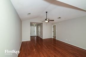Helena house for rent - a living room with wood floors and a ceiling fan