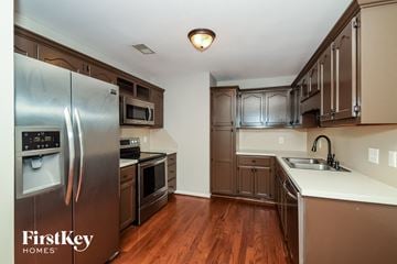 Helena house for rent - a kitchen with stainless steel appliances and a white counter top