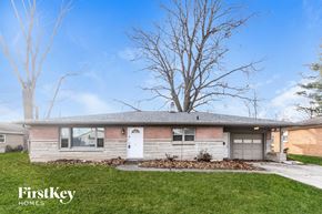 Plainfield house for rent - a small brick house with a white door and a tree