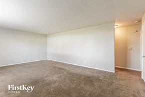Plainfield house for rent - an empty living room with white walls and carpet