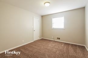 Plainfield house for rent - a bedroom with a carpeted floor and a window