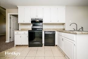 Fayetteville house for rent - A kitchen with white cabinets and a black oven.
