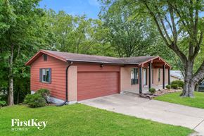 Saint Louis house for rent - a small red house with a sidewalk in front of it