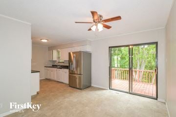 Saint Louis house for rent - a kitchen with a stainless steel refrigerator and a ceiling fan