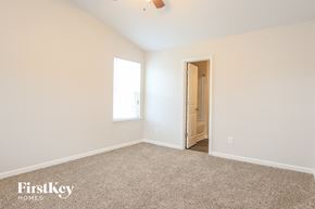 Clayton house for rent - a bedroom with carpet and a door to a bathroom
