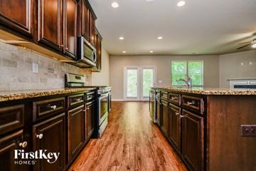 Mcdonough house for rent - A kitchen with wooden cabinets and a tile backsplash.