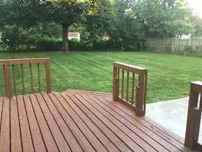 Pickerington house for rent - a backyard with a wooden deck and a lawn and trees
