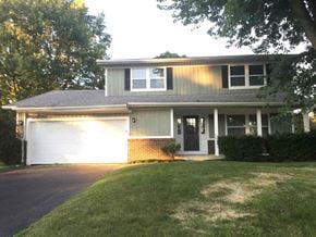 Pickerington house for rent - a house with a white garage door and a lawn
