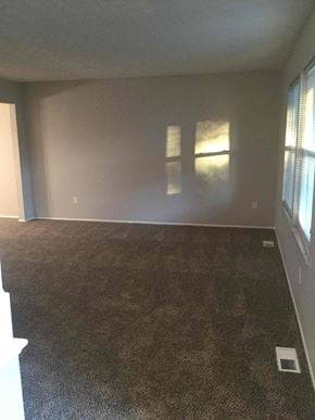 Pickerington house for rent - an empty living room with a carpeted floor