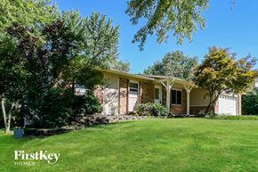 Saint Charles house for rent - a small brick house with a grassy lawn and trees