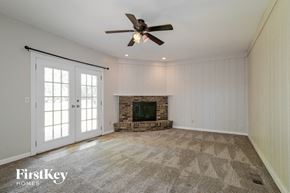 Saint Charles house for rent - a living room with a fireplace and a ceiling fan