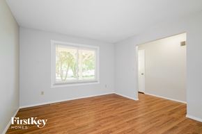 Saint Charles house for rent - the living room of a house with white walls and wood floors