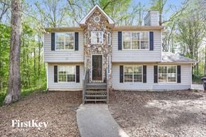 Covington house for rent - a white and blue house with a front porch and a driveway
