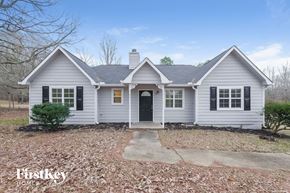 Senoia house for rent - a white house with black shutters and a black front door