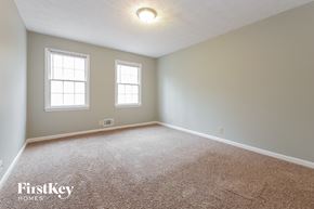 Senoia house for rent - the master bedroom with carpet and two windows