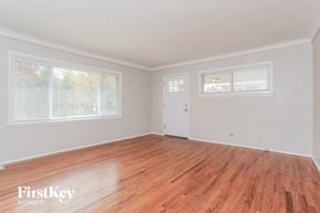 Cincinnati house for rent - the living room of a home with wood floors and white walls