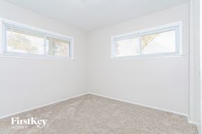 Cincinnati house for rent - the bedroom of a home with carpet and two windows